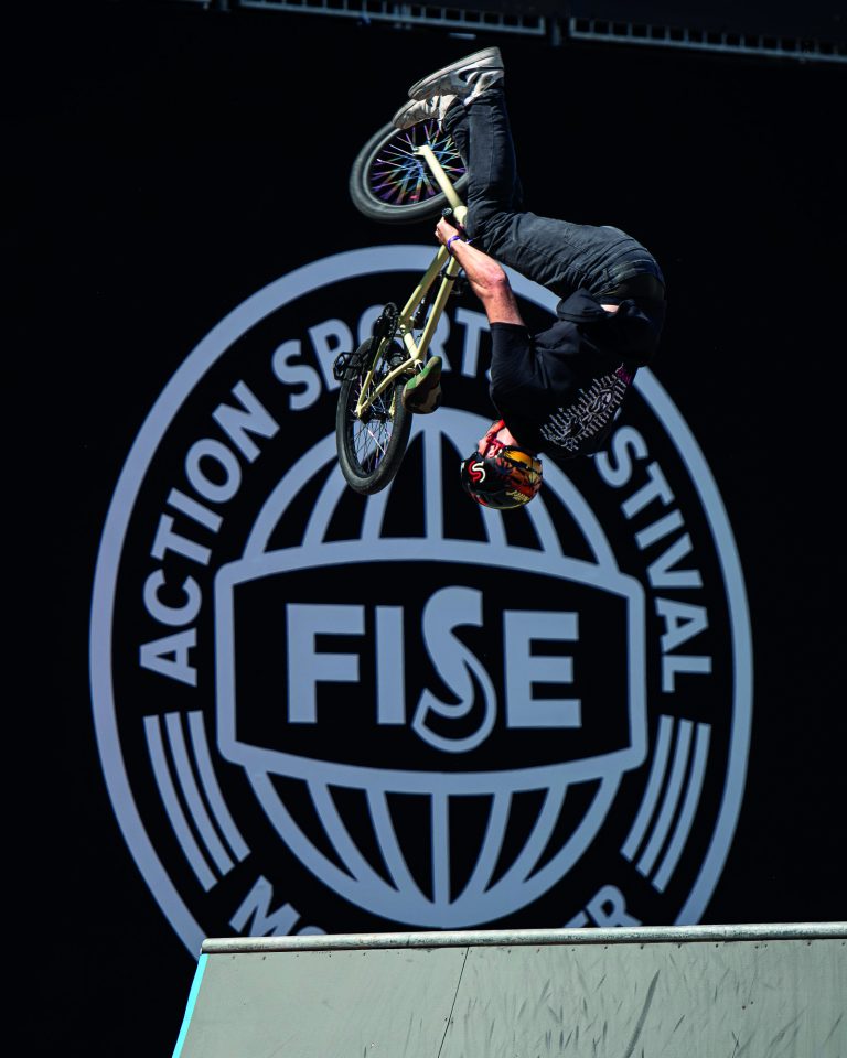 a man doing a trick on a bicycle