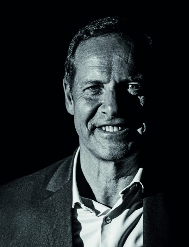 a man in a suit smiling